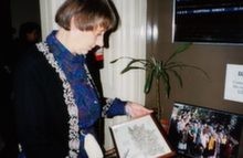 Dorrith looking at photo of Kinder reunion