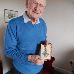 John holding his CBE