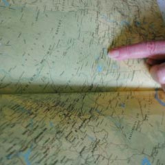 Marion pointing to site of camp