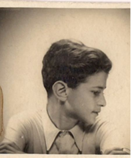Sepia photograph of Bob Kutner as a boy, seen in profile, in an open-collared shirt.