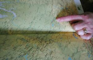 Marion pointing to site of camp